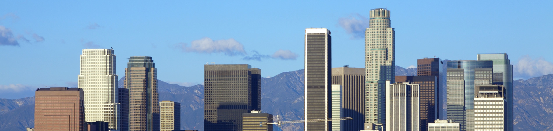 skyline over Los Angeles downtown with mountains behind